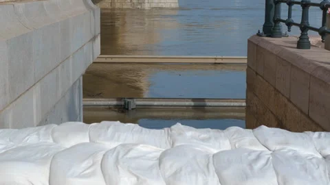 River water level decreasing showing sandbags protecting city 库存影片 287119128