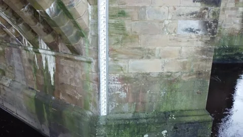 River Water Level Indicator on an Old Stone Bridge with moss in Yorkshire Stock Footage 167141468