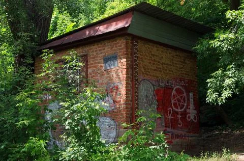 River water meter post with ruler and graffiti on the walls Stock Photos