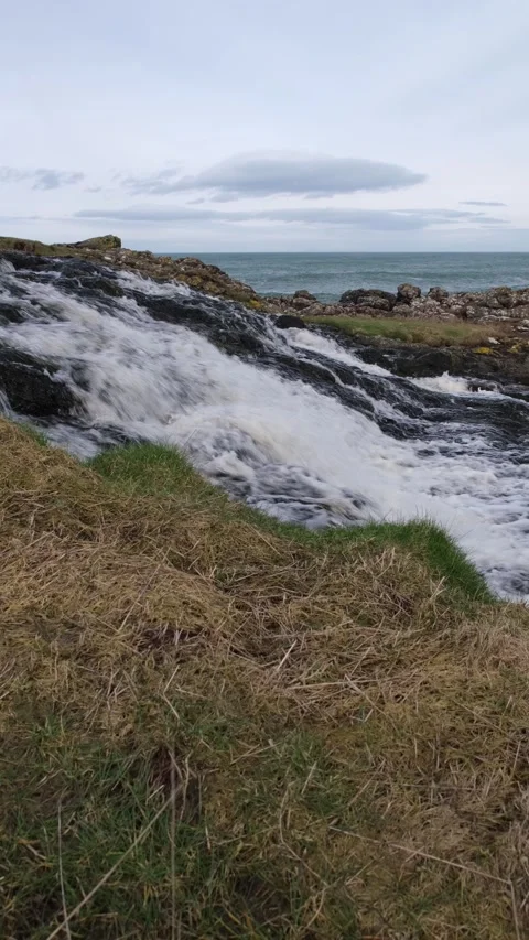 River water racing down Dunseverick Falls Stock-Footage 303451590