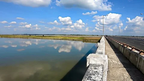 River water reflection with clear blue sky with many small cloud patch Stock Footage 129585380