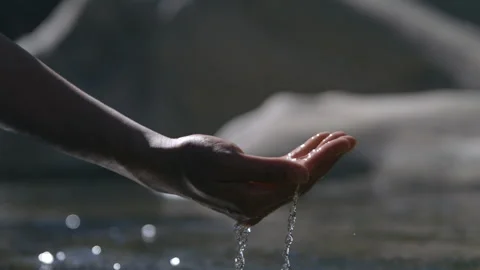 River Water Running Through Hand During Day in Slow Motion Video stock 270387575