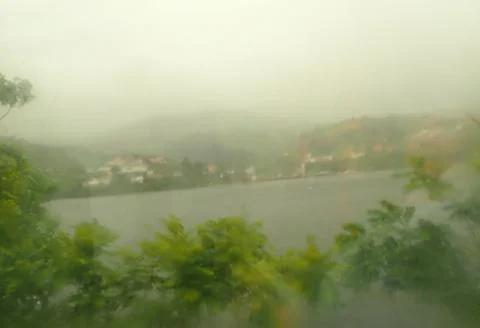 River water from train window on rainy day Stock Photos
