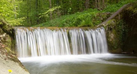 River waterfall (grey filter) in a forest on a sunny day Stock Photos