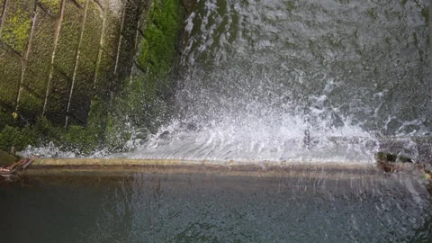 River waterfalls creating clean pollution free energy in hydro electric dam Stock Footage 270516622