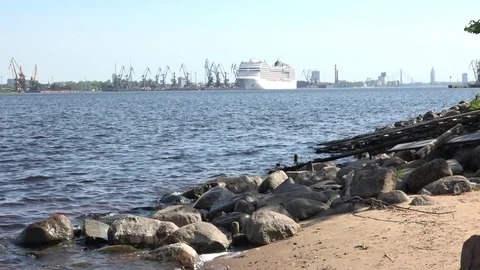 River with waves and grey stones on sand bank against liner Stock Footage 110845039