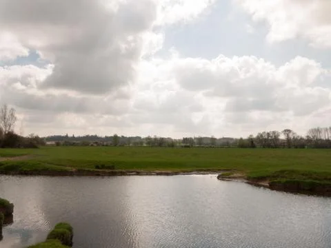 A River with A White Cloud Reflected in it Stock Photos