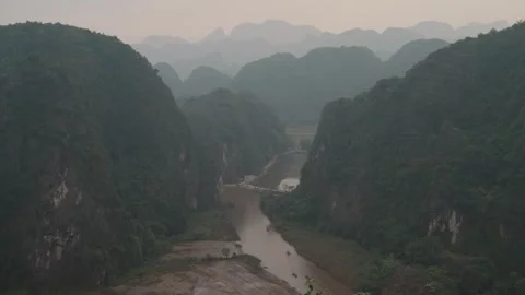 River winding through limestone karst landscape at Tam Coc, Ninh Binh, Vietnam Stock Footage 329796919