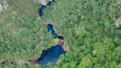 River winding through a lush green valley aerial wide Video stock 329104645