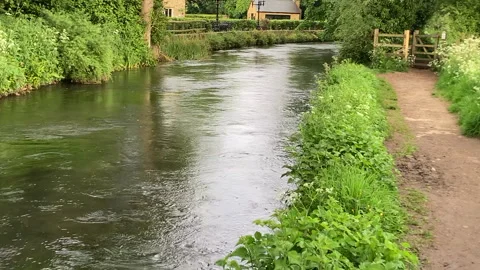 River Windrush flowing through Cotswolds village Stock Footage 275665286