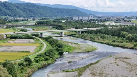 River winds through green fields and concrete bridges Stock Footage 343255651