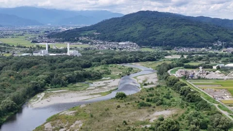 River winds through green hills and towns Video stock 343254953