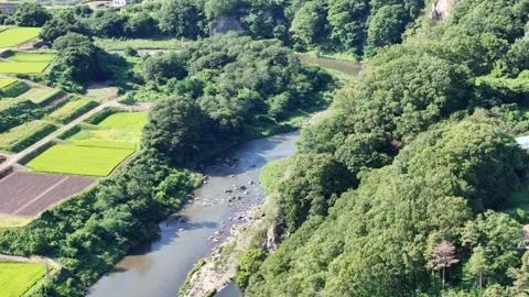 River winds through lush green hills and farmland Stock Footage 340918352