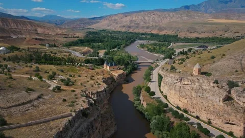 River winds through rugged canyon, flanked by ancient stone walls 스톡 동영상 332498819