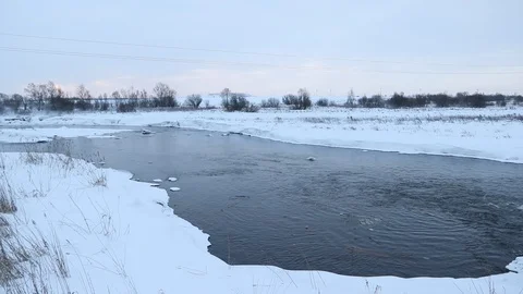 River in winter with snow. The river at dawn. Evaporation from water. Stock Footage 110052320
