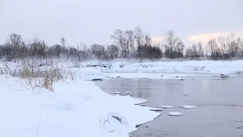 River in winter with snow. The river at dawn. Evaporation from water. Stock Footage 110057286