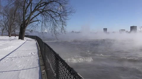 A river in the winter time with mist rising over rushing water.  Stock Footage 60644102