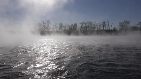 A river in the winter time with mist rising over rushing water.  Stock Footage 60644437
