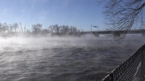 A river in the winter time with mist rising over rushing water. Stock Footage 60644530