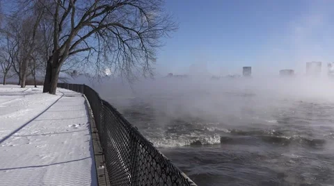 A river in the winter time with mist rising over rushing water.  Stock Footage 60644548