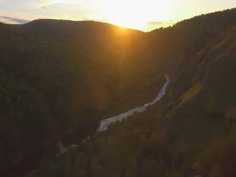 River in a wooden valley at sunset Stock Footage 80976216