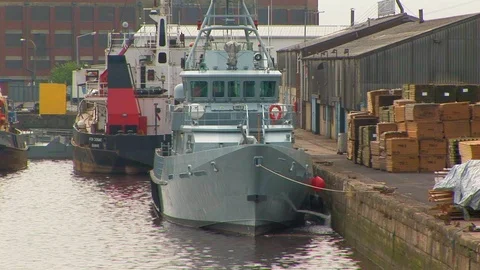 River work boats and boxed goods in the port of Hull at Kingston upon Hull, UK Stock Footage 105266321
