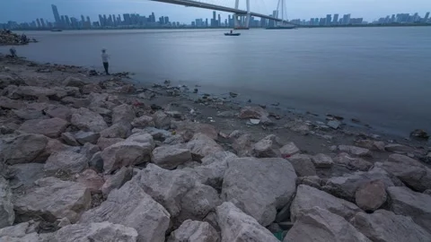 Riverbank Rocks Time-lapse with Flowing Water and Natural Shoreline View Stock Footage 326674067