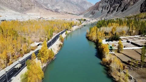 Riverbanks glowing with fall color in the remote mountains of Kargil. Stock Footage 310782204