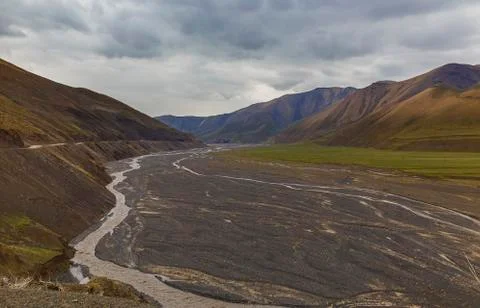 Riverbed in the mountains in the spring Stock Photos