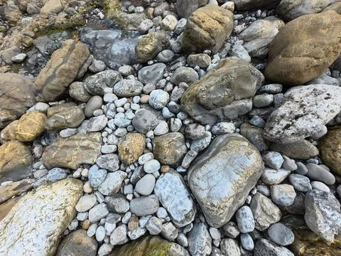 Riverbed rocks creating natural background texture pattern Stock Photos
