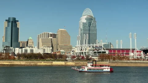 A riverboat floats down the Ohio river in front of the Cincinnati skyline Stock Footage 256950732