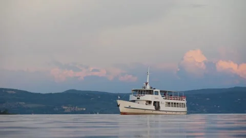 A Riverboat Passing on the Calm Water Surface of the Lake in the Evening Stock Footage 245282647