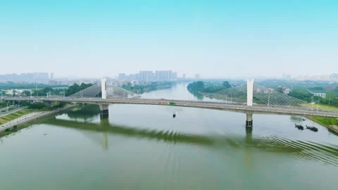 Riverboat wake beside a wide cable stayed crossing at Lichuan Bridge Stock Footage 346751253