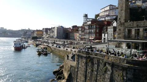 Riverfront filled with tourists on River Douro, Porto, Portugal. Sunny day. Stock Footage 105006193