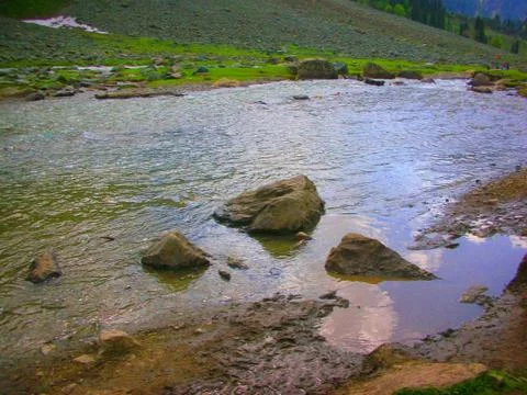 A riverfront in the mountains Stock Photos
