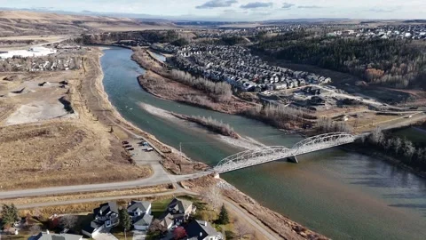 Riverfront new home development with walking paths and pedestrian bridge Stock Footage 296782696