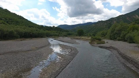 Riverfront pebbles aerial Stock Footage 99022309