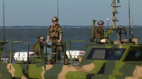 Riverine command boats leave an aircraft carrier with a strike team on board. Stock Footage 74808877