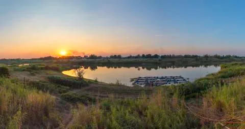 Riverside and sunset sky. Composition of nature. Stock Photos
