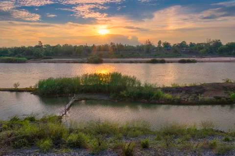 Riverside and sunset sky. Composition of nature. Stock Photos