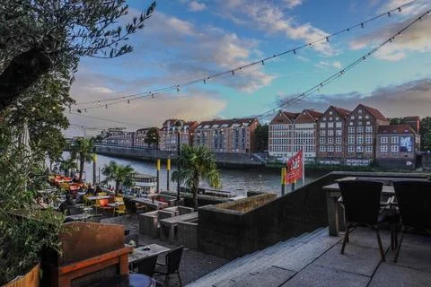 Riverside cafe terrace with string lights - Bremen, Germany 28.07.2024 Stock Photos