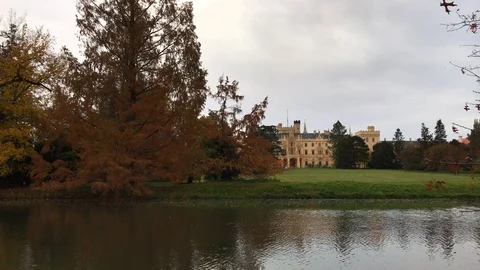 Riverside facade of Lednice castle and park in autumn Stock Footage 97873575
