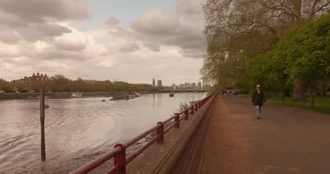 Riverside Path and Walkers by Battersea Park, London Embankment Stock Footage 337906182