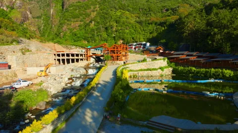 Riverside Resort with Small Bridge and Flowing Stream 4K Aerial Stock Footage 320550395