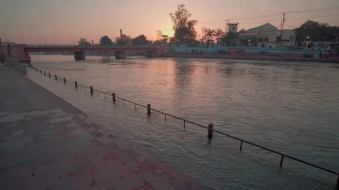 Riverside steps overlooking calm river in morning sunlight 库存影片 332920814