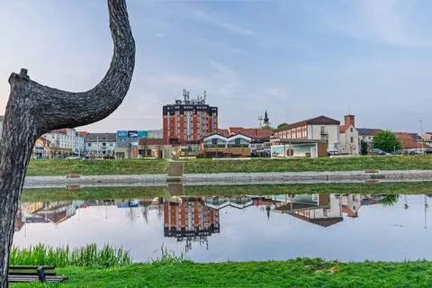 Riverside Town With Tree Foreground and Mirror Reflection on Calm Water at Du Stock Photos
