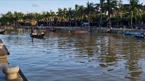 Riverside Tranquility: Serene River and Traditional Boats in Hoi An Stock Footage 240874992