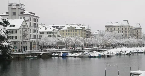 Riverside view of snow covered old town Zurich Switzerland from Minster bridge Stock Footage 146884331