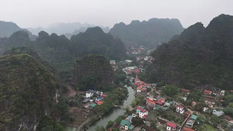 Riverside village surrounded by limestone karsts in Trang An, Ninh Binh, Vietnam Stock Footage 314818393