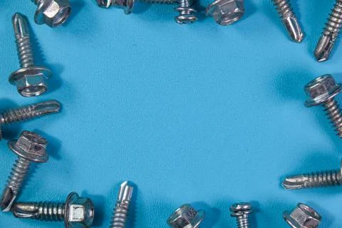 Rivet on blue background, manufacturing tools concept Stock Photos